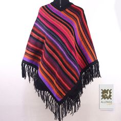 These ponchos are handmade by artisans from Cusco-Peru, a living Inca city. Our artisans who still preserve the traditional way weave by hand using Alpaca wool. Our very warm and cozy ponchos! ❤ With unique techniques and designs, these ponchos are handmade by Quechua artisans in the Andes. These luxurious wool ponchos are not only stunning and special but will keep you super warm in winter and fall. When cared for properly, these ponchos will last for years. The stunning and eye-catching design Peruvian Clothing, Peruvian Poncho, Alpaca Poncho, Boho Poncho, Black Poncho, Wool Gifts, Womens Poncho, Wool Sweaters Womens, Cusco Peru