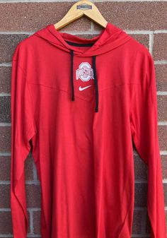 Put your Buckeyes spirit on display in this Ohio State Buckeyes Long Sleeve Hoodie! You'll be cozy on game day in this The Ohio State University Mens Red Sideline Top Hooded Sweatshirt. This Buckeyes Long Sleeve Hoodie features a need to update. Wear your Ohio State Buckeyes spirit with pride in this great Mens Hooded Sweatshirt! Nike Collegiate Sports Hoodie, Nike Collegiate Hoodie For Sports, Nike Cotton Moisture-wicking Hoodie, Nike Cotton Hoodie With Moisture-wicking, Nike Collegiate Hoodie, Nike Hoodie For Sports Season Fan Gear, University Red Sports Hoodie With Drawstring Hood, Nike Collegiate Hoodie With Drawstring Hood, Nike Collegiate Hooded Hoodie