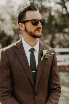 a man in a suit and tie wearing sunglasses