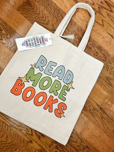 Who doesn't love a good bookish bag!?! This Read More Books bag is the perfect thing to carry all of your bookish things. This 100% cotton bag comes in one size - 15" x 16"- perfect for everyday wear. It is durable and will last for years. The bag features 20" handles (made from the same canvas), making it easy to carry even with a week's worth of shopping. .: 100% cotton canvas .: Heavy fabric (12 oz/yd�² (406.9 g/m .: Sewn-in label Best Tote Bags, Read More Books, Book Tote Bag, Girls Tote, Canvas Making, Book Shop, Bookish Things, Cute Tote Bags, Diy Book