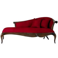 a red couch sitting on top of a wooden frame