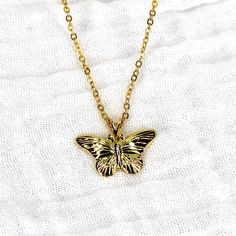 This necklace features a vintage gold plated butterfly pendant threaded on a modern 24k gold plated 16" chain. The necklace is tarnish resistant. Elegant Gold Butterfly Charm Necklace, Gold Butterfly Charm Pendant Necklace, Gold Butterfly Charm Necklace With Delicate Chain, Gold Butterfly Pendant Necklace With Clavicle Chain, Gold Pendant Necklace With Butterfly Charm, Gold Butterfly Necklace With Delicate Chain, Gold Dainty Butterfly Pendant Necklace, Dainty Gold Butterfly Pendant Necklace, Gold Butterfly Pendant Necklace With Delicate Chain