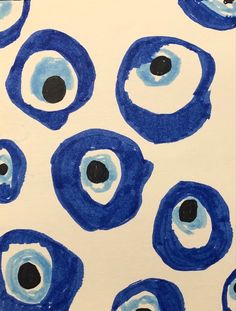 an abstract painting with blue circles and black dots on white paper that looks like eyeballs