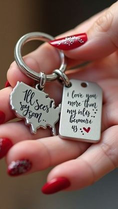 a woman's hand holding a keychain that says, i love you more than my wife