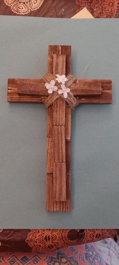 a cross made out of wood with flowers on it