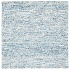 a blue and white rug with small waves on the bottom, in different sizes and colors