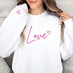 Love Crewneck Sweatshirt What the world needs now, is love sweet love... you know the tune. Try wearing your heart on your sleeve. Made with a medium-heavy fabric that consists of 50% cotton and 50% polyester for that cozy feel and warmth you need in a hoodie. .: The classic fit along with the pouch pocket and the tear-away label make for a highly comfortable, scratch-free wearing experience.  .: Made using 100% ethically grown US cotton. Gildan is also a proud member of the US Cotton Trust Protocol ensuring ethical and sustainable means of production. The blank tee's dyes are OEKO-TEX-certified dyes with low environmental impact. Long Sleeve T-shirt With Heart Graphic For Gift, Casual Heart Graphic Sweatshirt Gift, Heart Graphic Long Sleeve Top As Gift, Long Sleeve Tops With Heart Graphic For Gift, Long Sleeve Tops With Heart Graphic As Gift, Valentine's Day Gift Top With Long Sleeves, Valentine's Day White Casual Sweatshirt, White Casual Sweatshirt For Valentine's Day, Casual White Sweatshirt For Valentine's Day