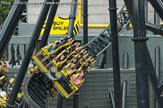 several people ride on roller coasters in an amusement park