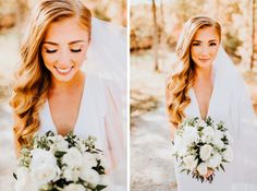 a bride holding her bouquet and smiling at the camera while standing in front of trees