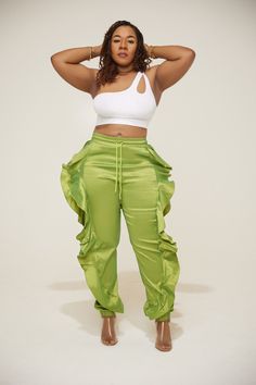 "ITEM DETAILS Elastic Waistband Ruffle Joggers Pants MATERIALS 90% polyester 10% spandex MEASUREMENTS  Insert measurements here MODEL STATS  Model stats: 5.3\" / Bust:40 / Waist:33\" / Hips:47\"" Green Stretch Parachute Pants With Elastic Waistband, High Waist Parachute Pants For Night Out In Spring, High Waist Parachute Pants For Spring Night Out, Stretch Green Cargo Pants For Spring, Fitted Green Bottoms With Ruffles, Summer Fitted Cargo Pants For Night Out, High-waist Green Ruffled Bottoms, Stretch High-waisted Parachute Pants For Spring, Fitted Cargo Pants For Summer Night Out