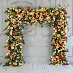 an arch made out of flowers on the floor