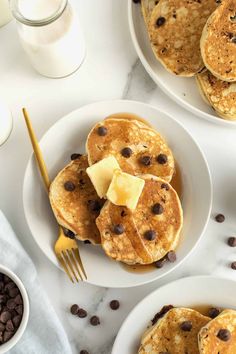 pancakes with chocolate chips and butter on white plates