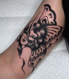 a black and white tattoo on the leg of a person