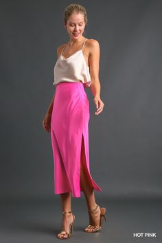 Description: The Sleek Satin Side-Slit Midi Skirt is the epitome of understated elegance, perfect for adding a touch of sophistication to your wardrobe. Crafted from a blend of 97% polyester and 3% spandex, this skirt offers a smooth, luxurious feel with just the right amount of stretch for comfort. The medium-weight satin fabric drapes beautifully, while the side slit adds a hint of allure and ease of movement. A discreet side zipper ensures a secure fit, making this skirt both practical and st Pink Satin Skirt Outfit, Pink Satin Skirt, Pink Skirt Outfits, Satin Skirt Outfit, Bright Winter, Satin Midi Skirt, Satin Skirt, Pink Skirt, Understated Elegance