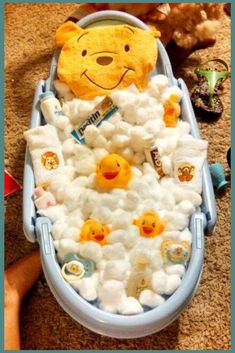 a teddy bear in a boat filled with marshmallows and other stuffed animals