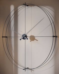 a clock that is on the wall with wires attached to it's face and hands