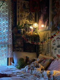 an unmade bed with stuffed animals on it in a room decorated with posters and lights