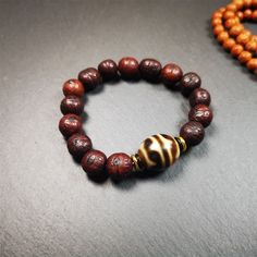 This unique Dalo Dzi bracelet combines the mysterious and unique qualities of the tiger tooth dalo dzi and 15 old bodhi seed beads,giving it a distinct feel.It is brown in color and has a circumference of approximately 7 inches, suitable for most wrist sizes.This bracelet can be worn not only as a fashionable accessory but also holds cultural and religious significance.Dzi beads are precious jewelry from Tibetan culture which are believed to possess the power of bringing good fortune to the owne Dzi Bracelet, Tibetan Culture, Tiger Tooth, The Tiger, Feel It, Precious Jewelry, Handmade Bracelets, Seed Beads, Beaded Bracelets