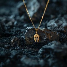 Channel your inner warrior with our Spartan helmet pendant. Handcrafted with precision, this bold piece symbolizes strength, bravery, and honor. Wear it as a reminder of your resilience and unyielding spirit, embracing the courage and determination of the legendary Spartan warriors. PENDANT INFORMATIONThis pendant is made of real, solid gold.• Made in USA• Size: MINI• Material: 14k or 18k solid gold• Finish: polished• Height: 1.15" (29 mm) x Width: 0.6" (14,5 mm)• Pendant weight (approx.): 3 gra Warrior Style Gold Necklaces As Gift, Engraved Warrior Style Pendant Jewelry, Warrior Style Engraved Pendant Jewelry, Warrior Style Engraved Sterling Silver Jewelry, Spartan Helmet, Inner Warrior, Spartan Warrior, Solid Gold Chains, Mini Pendants