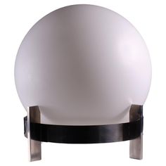 a large white ball sitting on top of a metal stand