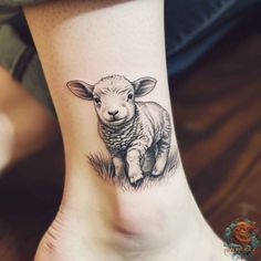 a small sheep tattoo on the ankle