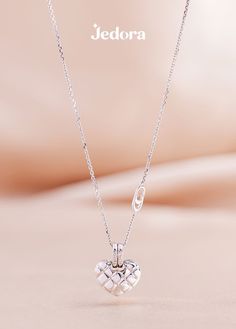 White gold heart shaped necklace with diamonds propped with a pink background Silver Heart Pendant Luxury Diamond Necklace, Luxury Silver Diamond Heart Pendant Necklace, Luxury Silver Heart Pendant Diamond Necklace, White Heart Diamond Necklace For Formal Occasions, White Gold Necklaces With Detachable Pendant For Weddings, Formal White Diamond Necklace For Valentine's Day, White Heart-shaped Diamond Necklace For Formal Occasions, White Heart-shaped Diamond Necklace For Formal Events, White Gold Necklace With Detachable Pendant For Wedding