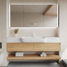 a bathroom with a sink, mirror and towels on the shelf in front of it