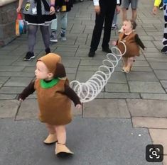 a small child in a monkey costume holding a string