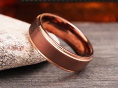 a close up of a wedding ring on a rock