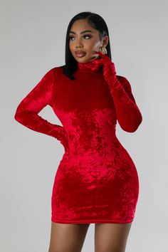 a woman wearing a red velvet dress with high neck and long sleeves, posing for the camera