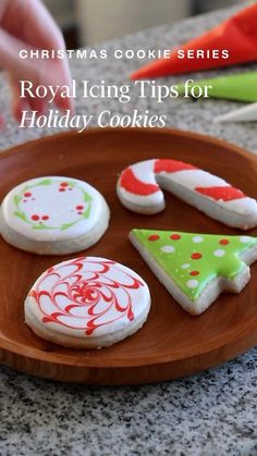 royal icing tips for holiday cookies are displayed on a wooden platter with red and green decorations