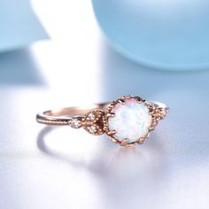 You are looking at a vintage Lab-created opal and round cut diamond engagement ring.A perfect anniversary gift, birthday gift,wedding engagement ring. Ring Information Main Stone *Lab-created opal *7mm round cut *Weight:it's approx 1.5 ct. *Setting:8-prong Side Stone *0.3 carat natural diamond Metal * Solid 10k 14k &18k. *Color:white gold,yellow gold,rose gold. Custom Order *The main stone can be other gemstones you can imagine,any birthstone can be made.Please contact me if you need this se Vintage Opal Promise Ring, Elegant Round Opal Ring For Marriage, Formal Rose Gold Opal Ring, Hallmarked Rose Gold Birthstone Ring, Vintage Opal Round Rings, Hallmarked Opal Wedding Ring, Hallmarked Opal Ring For Wedding, Heirloom Opal Wedding Ring, Heirloom Style Opal Wedding Ring