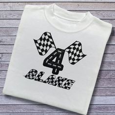 A Super Cute Personalised Birthday T-Shirt. Embroidered Applique Chequered Flag Design with the Age in Black Glittery Soft Vinyl in a Road Effect. The Name is also Embroidered in a Chequered Font. Perfect for Kids Birthdays.  Please only wash on a cool wash, do not tumble dry and do not iron directly on the design. Also, the Design will Look Larger or Smaller Depending on the Size of the Garment. Regular Unisex T-Shirt White, Black and Pink (up to size 5-6) 100% Supersoft Cotton (approx 200gsm) Embroidered Crew Neck Birthday T-shirt, Embroidered Crew Neck T-shirt For Birthday, Chequered Flag, Checkered Flag, Embroidered Applique, Personalized Embroidered, Top Cute, Flag Design, Kids Tops