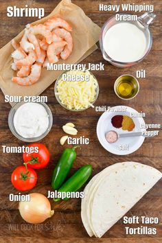 the ingredients to make shrimp tacos on a wooden table