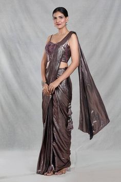 Copper brown shimmery pre-draped saree with iridescent stripes and tassel embellishments detailing. Paired with a strap sleeves sweetheart neck blouse with bloom embroidery using tonal cutdana, beads, sequin highlights. - Aza Fashions Sweetheart Neck Blouse, Bloom Embroidery, Sequins Blouse, Draped Saree, Strip Blouse, Embroidery Beads, Drape Saree, Copper Brown, Beaded Neckline