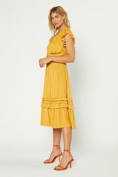 Our most popular dress is back in this classic marigold color. Allover pleating, fluttery cap sleeves, and sweet ruffle accents deliver a decidedly feminine look to this V-neck midi dress. Relaxed fit, size down for slimmer fit •Irregular pleating •V-neck •Cap sleeves •Allover pleating •Ruffle trim •Midi length DIMENSI Popular Dress, Marigold Color, Popular Dresses, V Neck Midi Dress, Pleated Midi Dress, Feminine Look, Lifestyle Brands, Ruffle Trim, Perfect Outfit