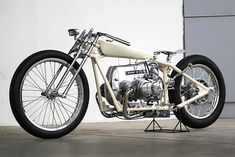 a white motorcycle parked in front of a building