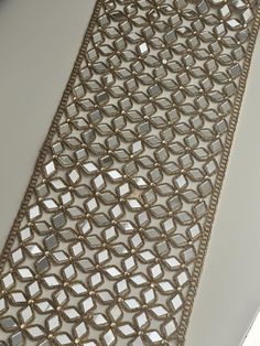 a close up view of a piece of cloth with gold thread and sequins