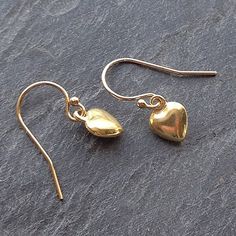 Sweet vermeil puffed gold heart charm earrings add just that little bit of dainty elegance to your ears.  They're a gorgeous buttery gold color and..... exquisite and perfectly formed.    Vermeil is a thick coating of carat gold on solid sterling silver. These petite hearts hang from top quality elegant ball ended 14kt gold fill earwires, they're light and easy to wear for everyday.  A symbol of love always makes the perfect gift! Matching necklace - https://etsy.me/2DiboCB* Length drop about 2c Minimalist Gold Heart Drop Earrings, Classic Gold Double Heart Earrings, Gold Heart-shaped Earrings As Gift For Her, Gold Heart Earrings As A Gift For Her, Gold Heart Earrings Gift For Her, Gold Dainty Heart Earrings Tarnish Resistant, Gold Heart-shaped Earrings For Her, Dainty Heart Drop Earrings For Gift, Minimalist Gold Hypoallergenic Heart Earrings