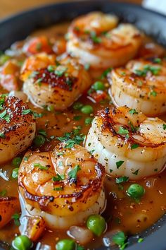 a plate filled with cooked shrimp and vegetables