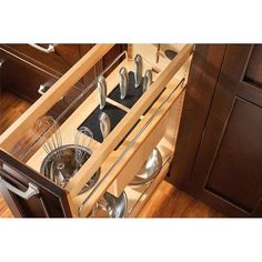 an open drawer with utensils in it