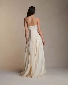 the back of a woman in a white dress