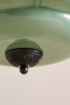 a green ceiling light hanging from the ceiling