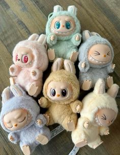 a group of stuffed animals sitting on top of a wooden floor