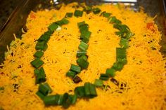 a casserole dish with green onions and cheese