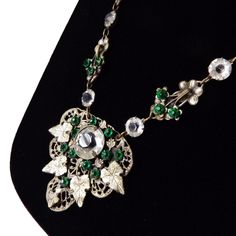 "Item: This is a gorgeous Bohemian pendant necklace with open backed crystals and green rhinestones. It has a fun vine and leaf design and was likely made in Czechoslovakia circa 1930. The setting is silver tone which shows wear through to the base metal (mostly on the reverse) and has a spring ring style clasp. Be sure to Favorite this piece and check our other listings for lots more antique and vintage jewelry! Signature: Unsigned Measurements: 19\" circumference, the pendant is 1 7/8\" w x 1 Crystal Necklace Pendant, Metal Style, Crystal Pendant, Spring Rings, Pandora Charm Bracelet, Fashion Rings, Silver Tone, Favorite Jewelry, Necklace Etsy