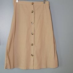 Classy Button Front Khaki Skirt. Perfect For A Work Or Casual Day. 16" Waist Unstretched With Elastic Waist Band.29" Length. Beige Relaxed Skirt With Button Closure, Knee-length Skirt With Side Buttons For Spring, Spring Knee-length Skirt With Side Buttons, Casual Skirt With Side Buttons For Spring, Beige Button Closure Midi Skirt, Beige Midi Skirt With Button Closure, Button-up Beige Skirt For Summer, Spring Beige Buttoned Skirt, Spring Beige Skirt With Buttons