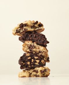 chocolate chip cookies stacked on top of each other in front of a white background,