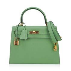 Guaranteed authentic Hermes Kelly Sellier 25 bag featured in fresh Vert Criquet. Stunning Hermes light green that is absolutely neutral. Luxurious with gold hardware.Epsom leather accentuates colours beautifully as it saturates to perfection. Comes with signature Hermes box, raincoat, shoulder strap, sleepers, lock, keys and clochette. NEW or NEVER WORN.The Hermes Kelly Sellier 25 cm bag price retains its value due to the rarity and high demand. As a purveyor of exceptional and unique Hermes lux Green Formal Satchel With Handles, Formal Green Satchel With Handles, Classic Green Satchel For Shopping, Green Formal Satchel With Top Handle, Green Top Handle Satchel For Formal Occasions, Green Luxury Satchel For Daily Use, Elegant Green Satchel For Office, Elegant Green Office Satchel, Classic Green Bag With Detachable Handle