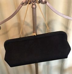 "This is a vintage, black purse, from the 50s or 60s. No labels or names inside. The purse has a single center compartment. The purse is made of black fabric. The hardware & optional chain handles are gold tone metal & it closes with a push clasp with a rhinestone centerpiece. The bag measures 5.5\" tall, 1-1/2\" across the bottom, and 12\" wide. Handle drop measures 5.5\". Inside is lined with fabric & the handle can be tucked inside for use as a clutch. It is in good, vintage condi Fabric Clutch, Structured Fabric, Black Purse, The 50s, Black Purses, Turtle Neck Top, Handbag Purse, Leather Tooling, Clutch Handbag